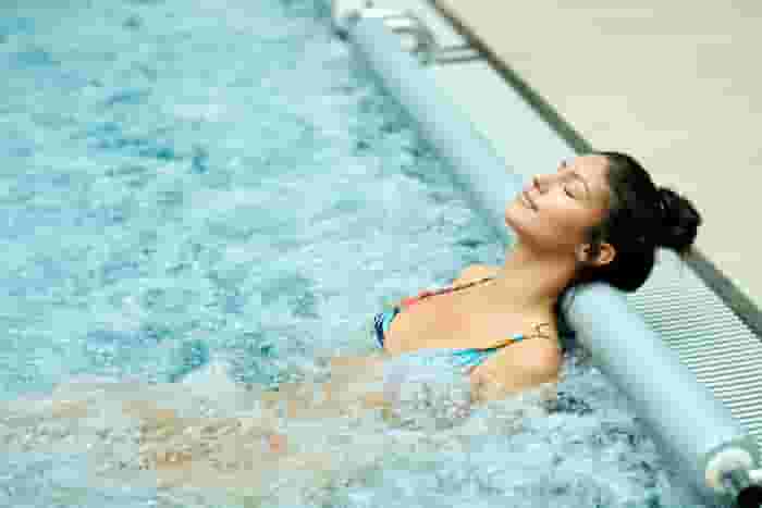 Resident relaxing in the spa at 805 Riverfront